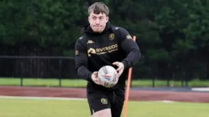 **Title: “Wigan Warriors Come to Salford’s Rescue: Star Duo Join Red Devils on Loan Amid Financial Crisis”**